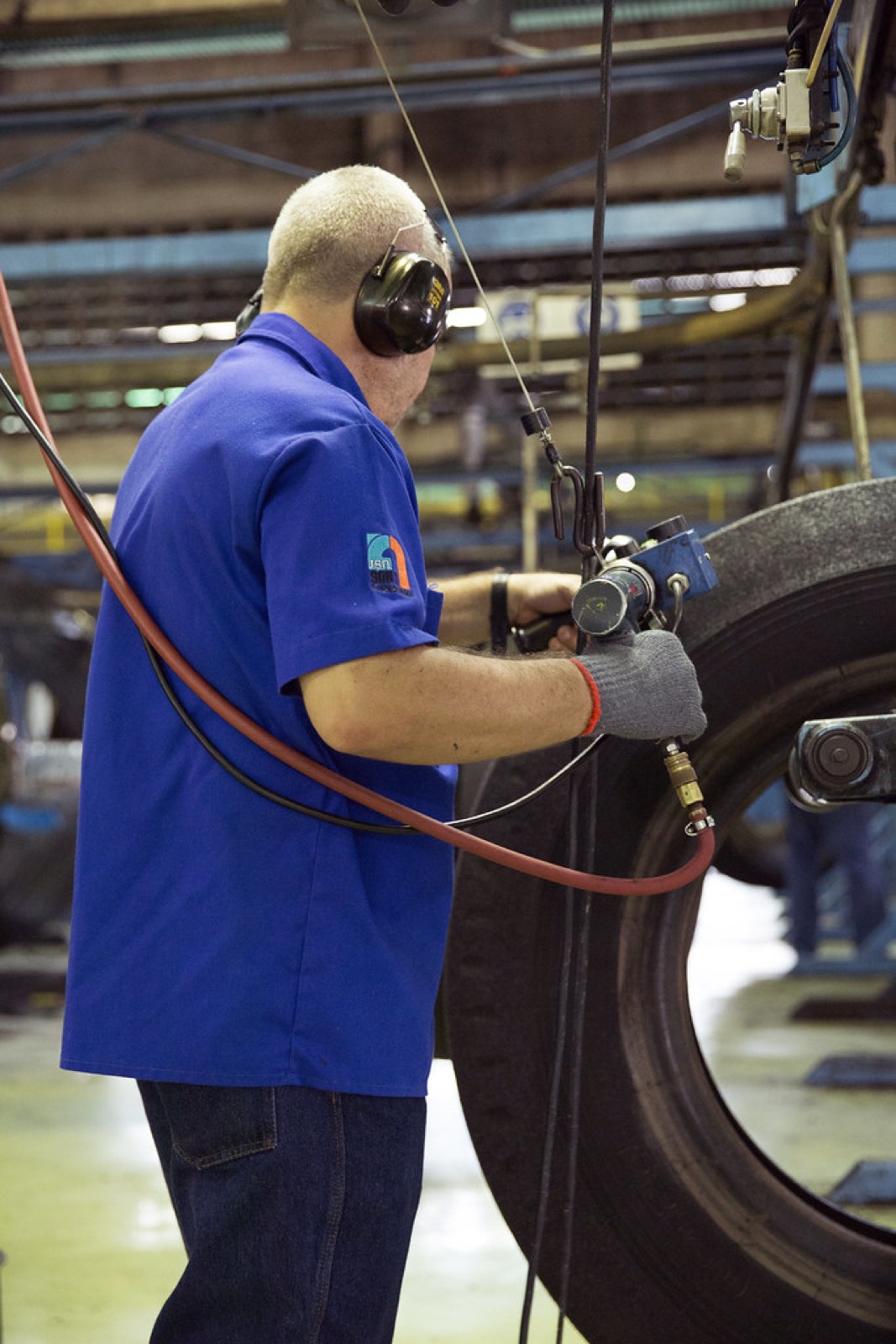 Technician working on equipment on a plant floor